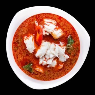 Red Curry Crab,Thai traditional food on black color background.